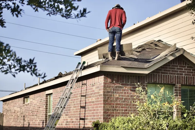 Professional roofer working on a residential roof in Lewisville Valley